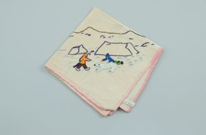 Image of Figure hunting a polar bear, one of a set of 2 embroidered napkins with polar bear hunting scenes